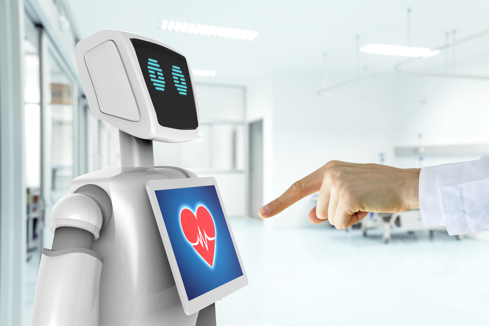 Doctor pointing at a heart emoticon on the chest of a robot